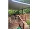 Covered deck perfect for outdoor gatherings, featuring wood railing and a shaded area at 734 Harris Nw St, Concord, NC 28025
