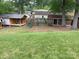 Spacious backyard featuring a play structure, and storage sheds at 734 Harris Nw St, Concord, NC 28025