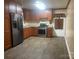 Eat-in kitchen with stainless steel appliances, lots of cabinets, and modern vinyl flooring at 734 Harris Nw St, Concord, NC 28025