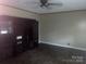 Living room showcases a large entertainment center and modern wood-look flooring at 734 Harris Nw St, Concord, NC 28025