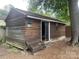 Rustic outbuilding with wood siding and an open door, perfect for storage or workshop at 734 Harris Nw St, Concord, NC 28025