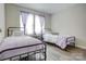 Inviting bedroom featuring twin beds, hardwood floors, soft lighting, and a cozy ambiance at 809 Fisher St, Kannapolis, NC 28027