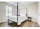 Bright bedroom featuring a four-poster bed and wood-look flooring at 809 Fisher St, Kannapolis, NC 28027