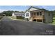 Home with fresh asphalt driveway and covered front porch at 809 Fisher St, Kannapolis, NC 28027