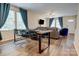 Open-concept dining and living area with hardwood floors, large windows, and contemporary furnishings at 809 Fisher St, Kannapolis, NC 28027