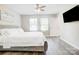 Bright main bedroom with large windows, hardwood floors, neutral decor, and a large bed at 809 Fisher St, Kannapolis, NC 28027