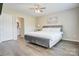 Serene main bedroom with a plush bed, hardwood floors, and neutral decor at 809 Fisher St, Kannapolis, NC 28027