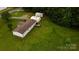 Aerial view showing yard, buildings, deck, and proximity to wooded area at 8140 Karriker Rd, Kannapolis, NC 28081