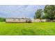 Spacious backyard featuring green grass, a shed, and a wooden deck at 8140 Karriker Rd, Kannapolis, NC 28081