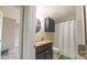 Bathroom featuring granite countertops, black cabinets, and shower with accents at 8140 Karriker Rd, Kannapolis, NC 28081