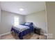 This bedroom features a comfortable bed and a bright window at 8140 Karriker Rd, Kannapolis, NC 28081