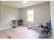 Bedroom with desk and exercise equipment, bright natural light at 8140 Karriker Rd, Kannapolis, NC 28081