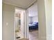 Hallway leading to bathroom with shower and bedroom with blue bedspread at 8140 Karriker Rd, Kannapolis, NC 28081