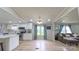 Bright open living area featuring modern white kitchen, natural light and wood-look flooring at 8140 Karriker Rd, Kannapolis, NC 28081