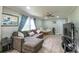 Cozy living room with comfortable seating, ceiling fan, decor, and luxury vinyl plank flooring at 8140 Karriker Rd, Kannapolis, NC 28081
