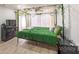 Comfortable bedroom featuring a modern canopy bed frame, luxury vinyl plank flooring, and bright light at 8140 Karriker Rd, Kannapolis, NC 28081