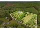Panoramic aerial view highlighting the expansive property, bordering road and lush surroundings of the countryside at 1046 Linneys Mill Rd, Union Grove, NC 28689