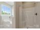 Modern bathroom featuring a separate tub and shower, illuminated by natural light at 1046 Linneys Mill Rd, Union Grove, NC 28689