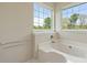 Clean bathroom featuring a soaking tub and natural light from two windows at 1046 Linneys Mill Rd, Union Grove, NC 28689