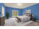 Comfortable bedroom with a large window, neutral decor, and warm lighting at 1046 Linneys Mill Rd, Union Grove, NC 28689