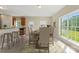 Open dining area featuring a breakfast bar, dining table, and large windows with a view at 1046 Linneys Mill Rd, Union Grove, NC 28689