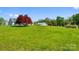 Expansive front yard view featuring a well-maintained lawn, mature trees, and a picturesque home at 1046 Linneys Mill Rd, Union Grove, NC 28689