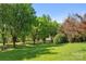 Expansive front yard with mature trees and lush green grass, creating a serene and inviting outdoor space at 1046 Linneys Mill Rd, Union Grove, NC 28689