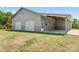 Spacious two car detached garage and carport with an open side and white doors, set on a large lot at 1046 Linneys Mill Rd, Union Grove, NC 28689