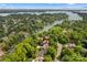 Stunning aerial view of a lakeside home nestled among lush greenery, showcasing its prime waterfront location at 110 Preserve Way, Mooresville, NC 28117