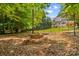 A backyard shows a fire pit area with a fenced in yard and a light colored house in the background at 110 Preserve Way, Mooresville, NC 28117