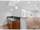 Basement bar with wood cabinets, and granite countertop at 110 Preserve Way, Mooresville, NC 28117