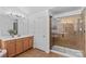 Bathroom featuring a glass shower and a wood vanity with sink and decorative lighting at 110 Preserve Way, Mooresville, NC 28117