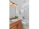 Bathroom with granite countertop, wood cabinets, shower-tub and tiled walls at 110 Preserve Way, Mooresville, NC 28117