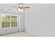 Bright bedroom with a ceiling fan and a large window overlooking lush greenery at 110 Preserve Way, Mooresville, NC 28117