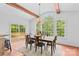 Sunlit dining area with wood beams, large windows, and sliding door access to deck at 110 Preserve Way, Mooresville, NC 28117