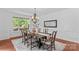 Bright dining room featuring a wooden table, chandelier, and large windows, perfect for Gathering meals and gatherings at 110 Preserve Way, Mooresville, NC 28117