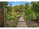 Backyard view of a private dock with a boat and serene lake surrounded by lush greenery at 110 Preserve Way, Mooresville, NC 28117