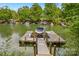 A boat is loaded onto a private dock with a boat lift offering premier access to the lake at 110 Preserve Way, Mooresville, NC 28117