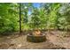 An inviting brick fire pit surrounded by manicured gravel offers a cozy outdoor gathering space at 110 Preserve Way, Mooresville, NC 28117
