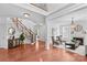 Welcoming foyer with a staircase, hardwood floors, and a view into the living room with a fireplace at 110 Preserve Way, Mooresville, NC 28117