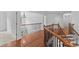 Hallway with hardwood floors and a wooden staircase featuring dark wrought iron spindles at 110 Preserve Way, Mooresville, NC 28117