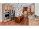 Well-equipped kitchen featuring stainless steel appliances, wooden cabinetry, and granite countertops at 110 Preserve Way, Mooresville, NC 28117