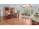Open kitchen and dining area with wood floors, center island, and large windows at 110 Preserve Way, Mooresville, NC 28117