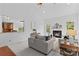 Bright living room with fireplace, plush seating, and seamless open-concept view to kitchen at 110 Preserve Way, Mooresville, NC 28117