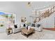Inviting living room boasts large windows, neutral furnishings, and an open floor plan at 110 Preserve Way, Mooresville, NC 28117
