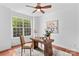 Bright office space with a modern desk and a large window overlooking the front yard at 110 Preserve Way, Mooresville, NC 28117