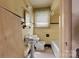 Dated bathroom with small tiles on the floor and yellow tiles on the wall at 114 S 5Th St, Albemarle, NC 28001