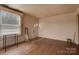 Cozy room with hardwood floors, a window with blinds, and neutral walls at 114 S 5Th St, Albemarle, NC 28001