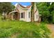 Another side view showcasing the architecture, chimney detail, and the home's natural setting at 114 S 5Th St, Albemarle, NC 28001