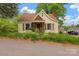 Charming home with a stone chimney and overgrown front yard at 114 S 5Th St, Albemarle, NC 28001